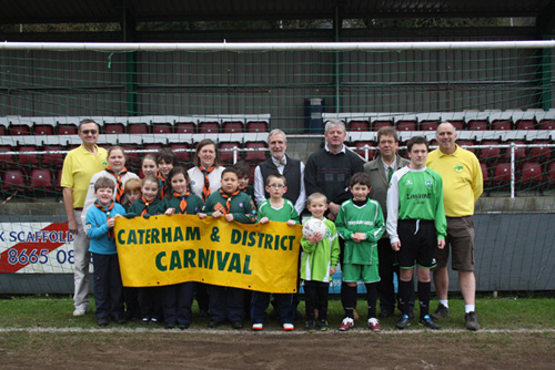 Caterham Carnival Committee members Martin Vaux (far left) and Andy Parr (far right) with representatives of this year's carnival beneficiaries at Whyteleafe FC.